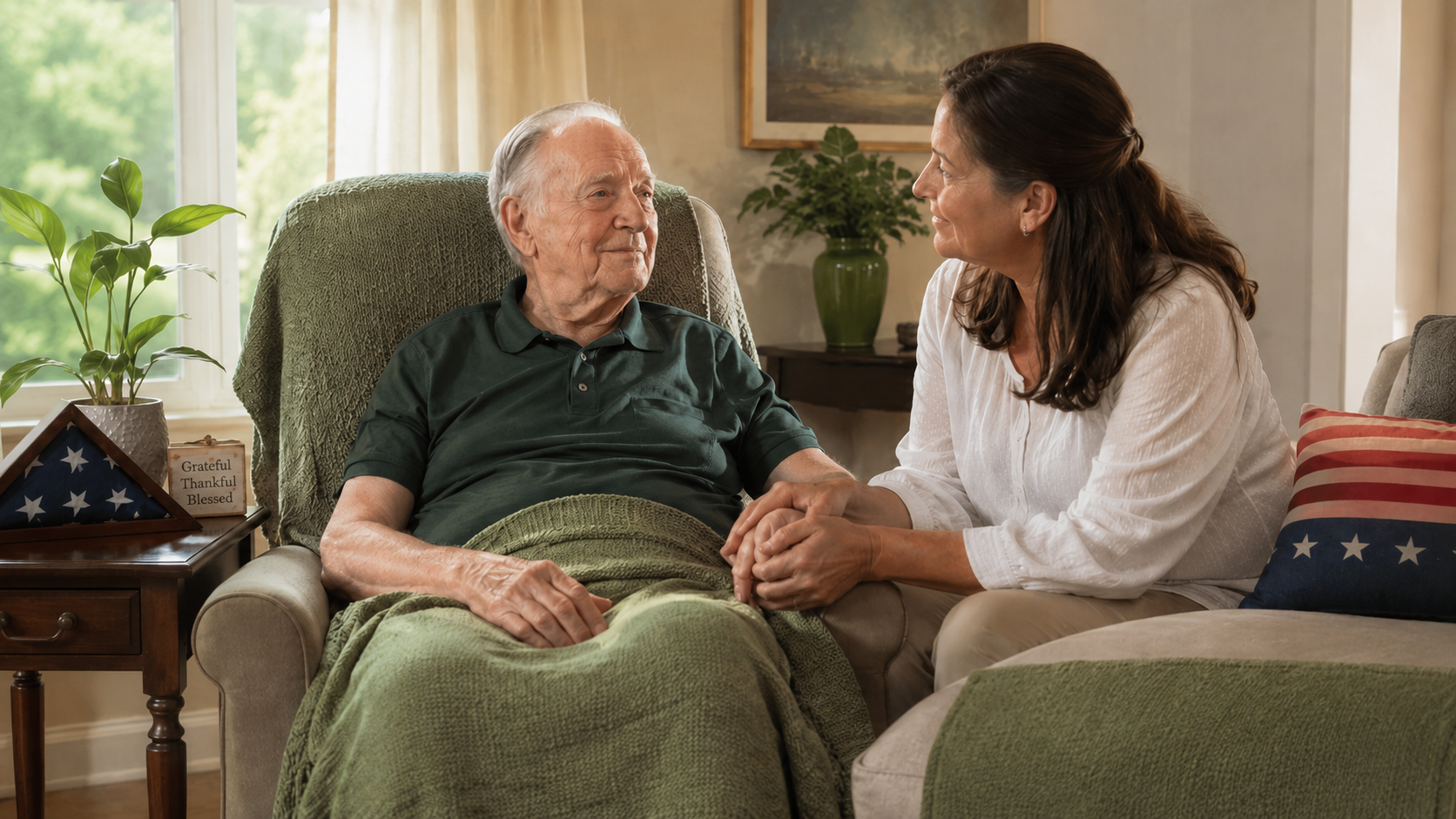Loved one sitting beside a person in hospice care at home with subtle Fourth of July accents, representing comfort during holidays in hospice care
