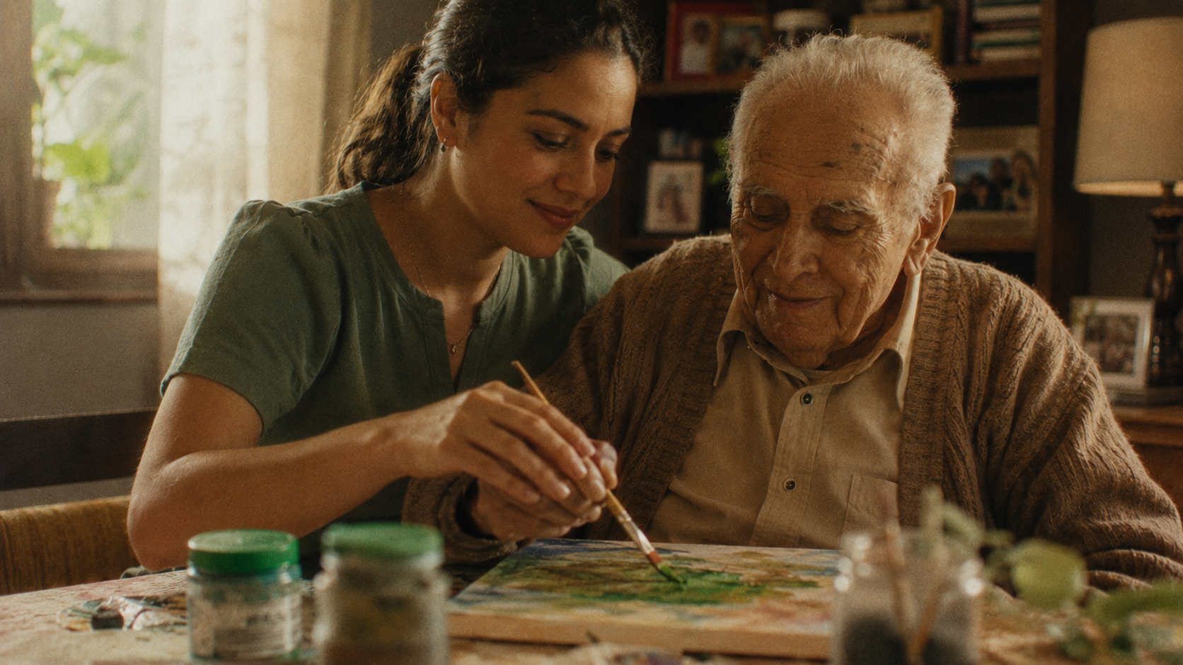 Hospice volunteer helping an elderly man paint at home, showing companionship and support in hospice volunteering